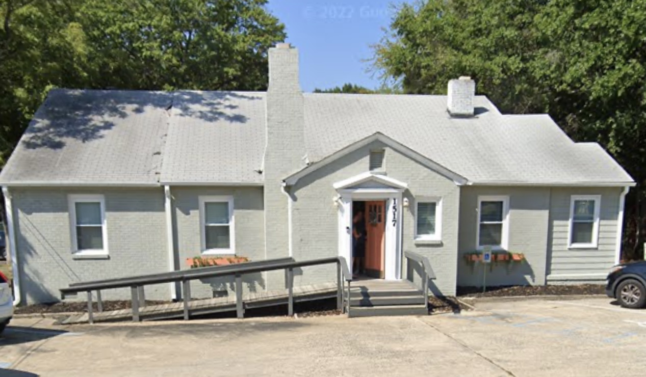 The front of the building at 1517 Ebenezer Rd with its orange door and ramp