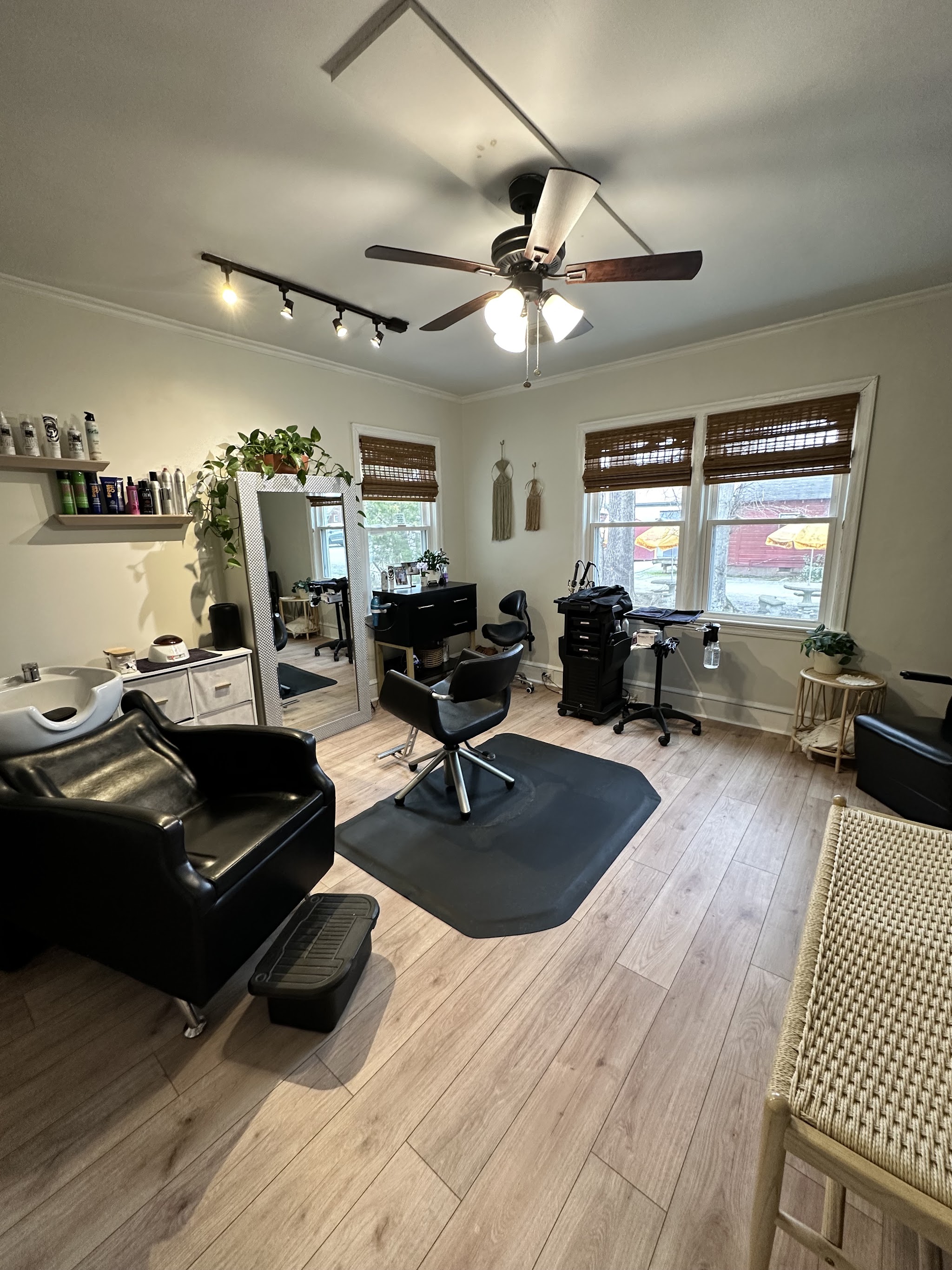 The studio with a mirror, product shelf and my styling chair by the windows